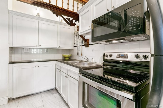 kitchen featuring sink, white cabinetry, decorative backsplash, and stainless steel appliances