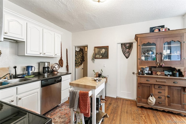 kitchen with dishwasher, a textured ceiling, white cabinetry, stove, and dark hardwood / wood-style floors