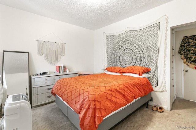 bedroom with carpet floors and a textured ceiling