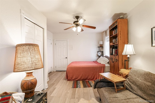 bedroom featuring light hardwood / wood-style flooring, a closet, and ceiling fan