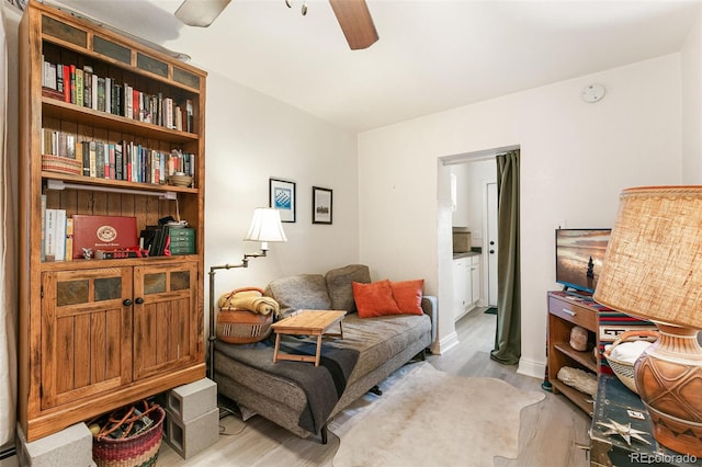 sitting room featuring light hardwood / wood-style floors and ceiling fan