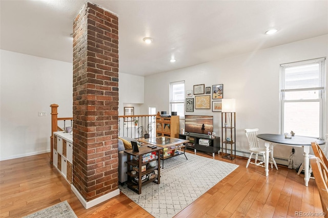 interior space featuring a wealth of natural light, ornate columns, and hardwood / wood-style flooring