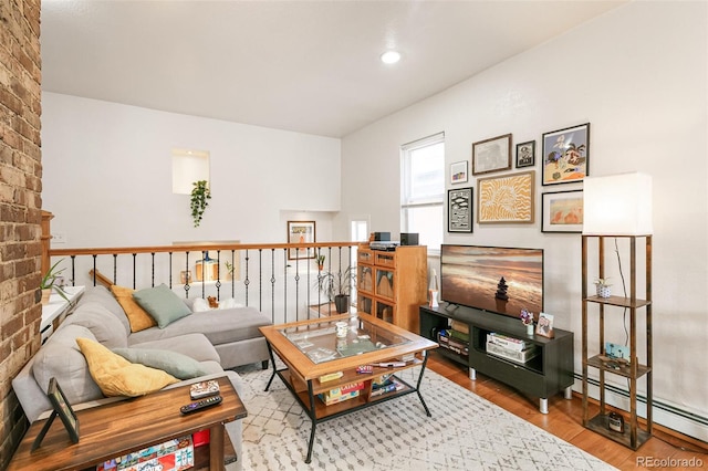 living room with hardwood / wood-style flooring and baseboard heating