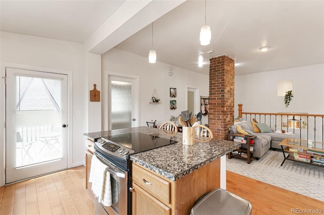 kitchen featuring pendant lighting, light hardwood / wood-style flooring, ornate columns, and stainless steel range with electric cooktop