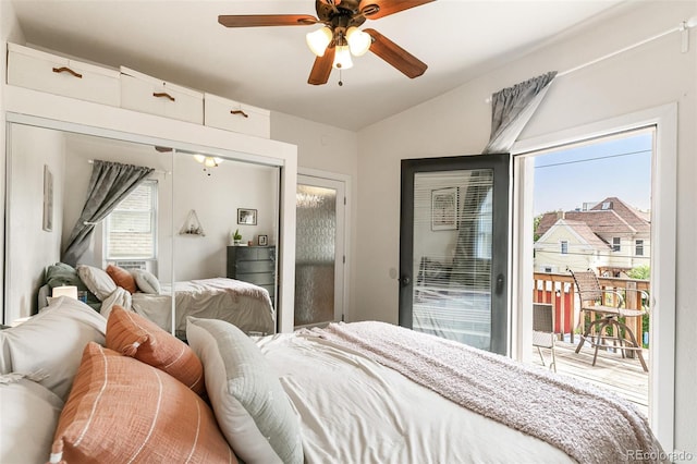 bedroom featuring lofted ceiling, access to exterior, multiple windows, and ceiling fan