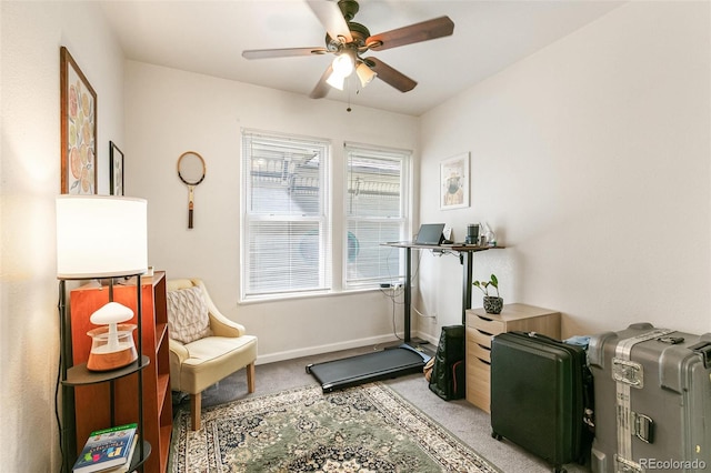 living area with light carpet and ceiling fan