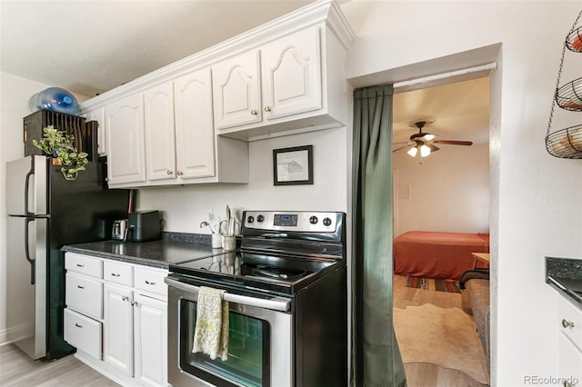 kitchen featuring light hardwood / wood-style floors, white cabinets, stainless steel appliances, and ceiling fan