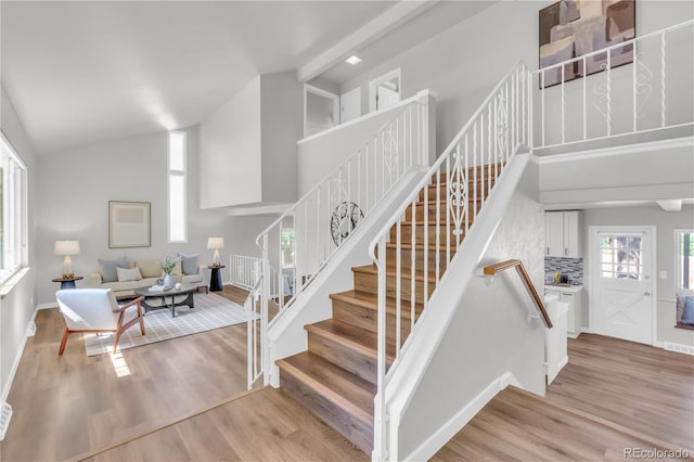 7055 S Costilla St, Littleton, CO 80120 - stairs featuring high vaulted ceiling and wood finished floors