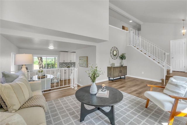 7055 S Costilla St, Littleton, CO 80120 - living room featuring wood finished floors, stairs, and high vaulted ceiling