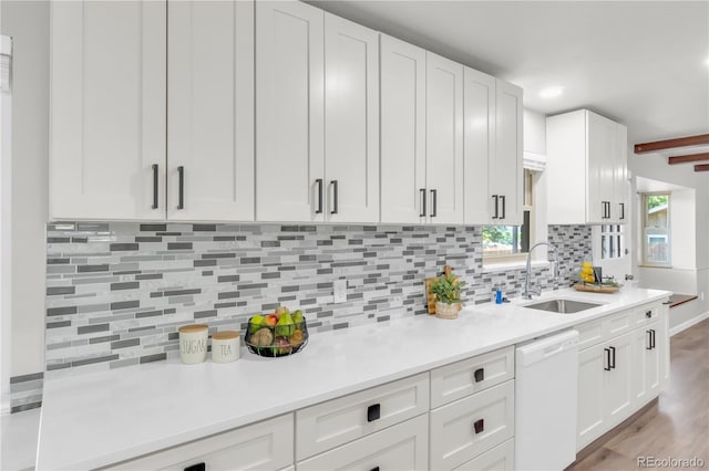 7055 S Costilla St, Littleton, CO 80120 - kitchen featuring dishwasher, white cabinets, light countertops, and backsplash