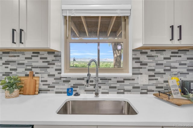 7055 S Costilla St, Littleton, CO 80120 - kitchen with light countertops, white cabinets, and decorative backsplash