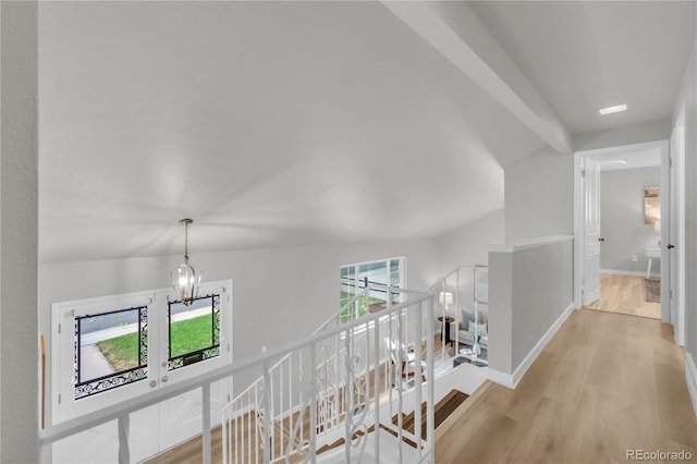 7055 S Costilla St, Littleton, CO 80120 - corridor featuring wood finished floors, an upstairs landing, and a chandelier
