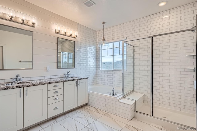 bathroom with vanity and independent shower and bath