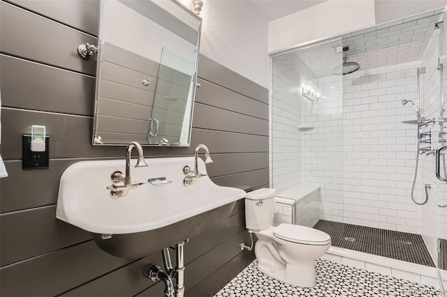 bathroom with sink, tile patterned flooring, a shower with door, and toilet