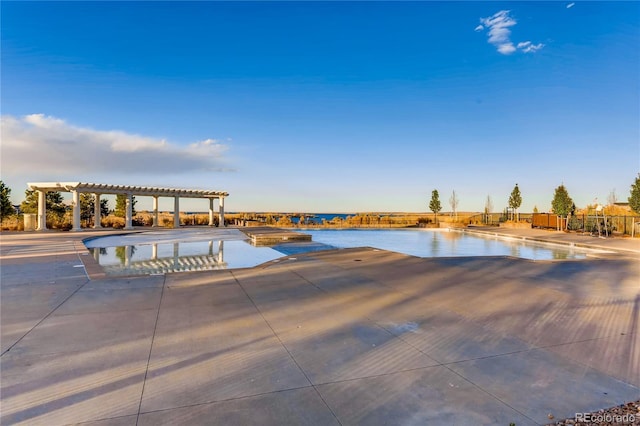 view of swimming pool with a pergola, a water view, a patio, and a hot tub