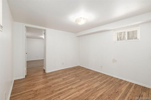 unfurnished room featuring light wood-type flooring and baseboards