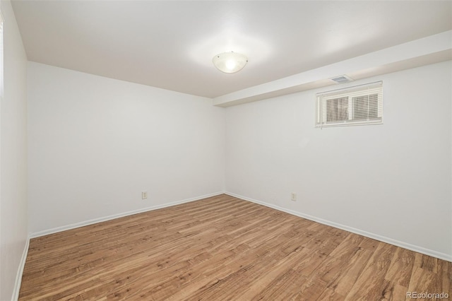 empty room with light wood-type flooring and baseboards