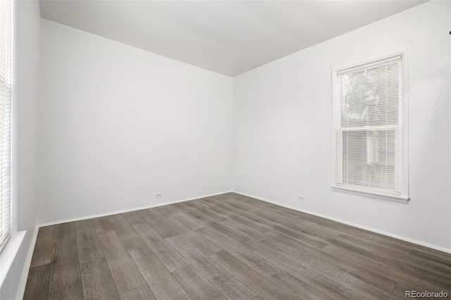 empty room featuring baseboards and wood finished floors