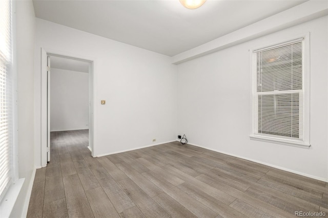 unfurnished room featuring wood finished floors and baseboards