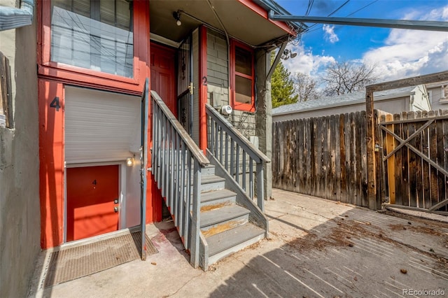 doorway to property featuring fence