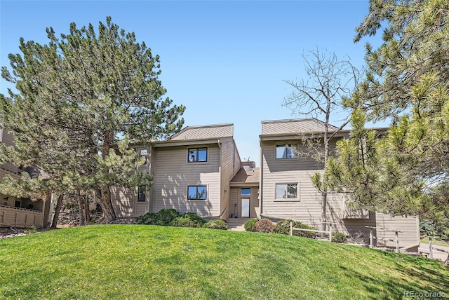 back of property featuring a yard