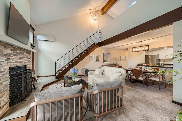 living room featuring a fireplace, high vaulted ceiling, beamed ceiling, an AC wall unit, and stairs