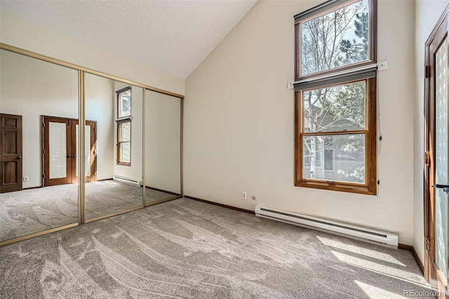 unfurnished bedroom featuring carpet flooring and baseboard heating