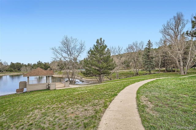 view of home's community featuring a water view and a yard