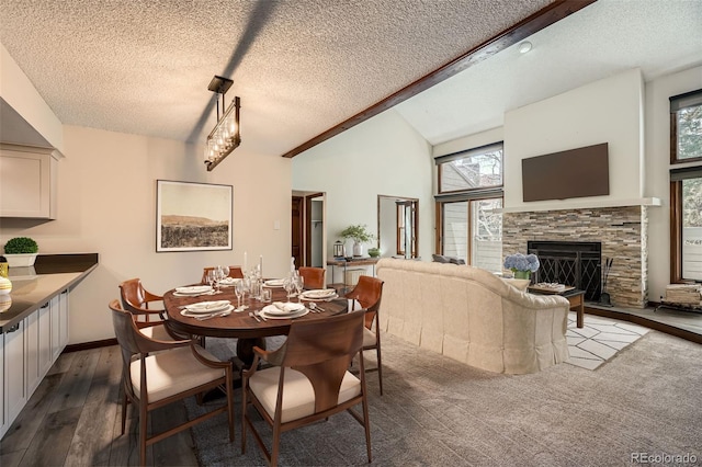 dining room featuring a fireplace, a textured ceiling, vaulted ceiling, and hardwood / wood-style floors