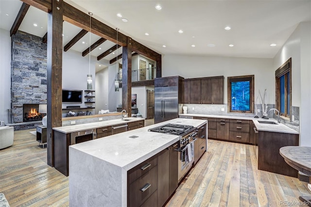 141 Sawmill Run Dr, Breckenridge, CO 80424 - kitchen with a kitchen island, premium appliances, light wood-style floors, dark brown cabinets, and modern cabinets