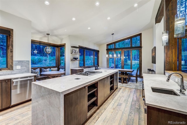 141 Sawmill Run Dr, Breckenridge, CO 80424 - kitchen with dishwasher, open shelves, a kitchen island, light wood finished floors, and modern cabinets