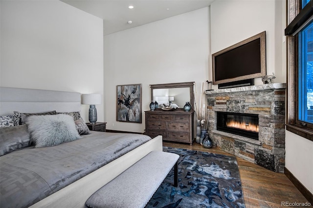 141 Sawmill Run Dr, Breckenridge, CO 80424 - bedroom with a stone fireplace, wood finished floors, and recessed lighting