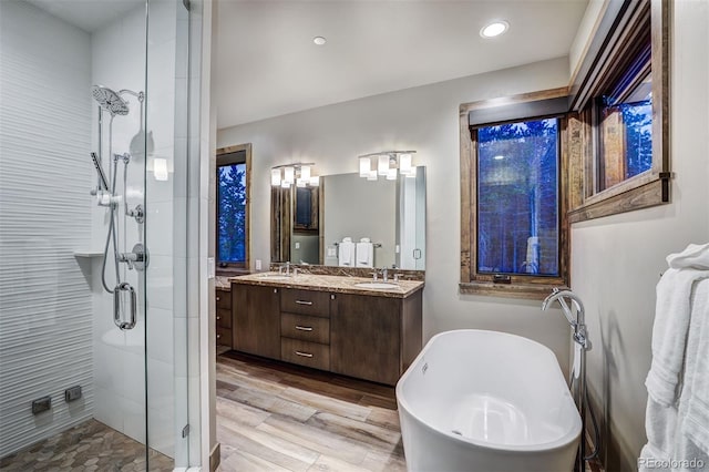 141 Sawmill Run Dr, Breckenridge, CO 80424 - full bathroom with a shower stall, double vanity, a freestanding tub, wood finished floors, and recessed lighting