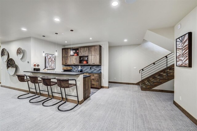 141 Sawmill Run Dr, Breckenridge, CO 80424 - kitchen with open shelves, a kitchen bar, dark countertops, recessed lighting, and tasteful backsplash