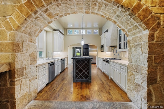850 E Radcliff Ave, Cherry Hills Village, CO 80113 - kitchen featuring stainless steel appliances, a center island, dark wood-style floors, white cabinets, and a towering ceiling