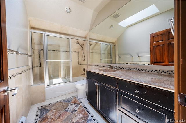 850 E Radcliff Ave, Cherry Hills Village, CO 80113 - full bathroom with a skylight, vanity, tile patterned floors, enclosed tub / shower combo, and lofted ceiling