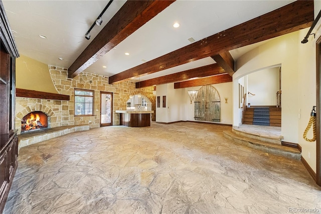 850 E Radcliff Ave, Cherry Hills Village, CO 80113 - unfurnished living room featuring beamed ceiling, stone floors, a stone fireplace, stairs, and recessed lighting