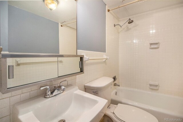 1020 15th St Unit 7A, Denver, CO 80202 - full bath featuring tile walls, bathtub / shower combination, a sink, and toilet