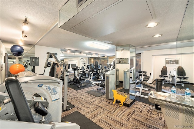 gym featuring carpet floors, visible vents, and a textured ceiling