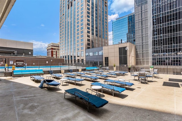 pool featuring a city view and a patio