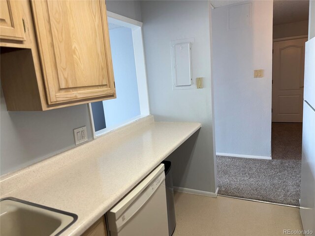 kitchen featuring white dishwasher, baseboards, light countertops, and light brown cabinetry