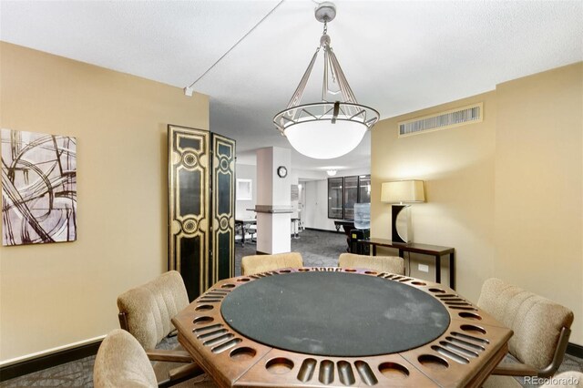 carpeted dining space with visible vents