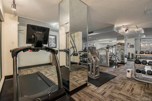 1020 15th St Unit 7A, Denver, CO 80202 - gym featuring carpet floors, a textured ceiling, baseboards, and visible vents
