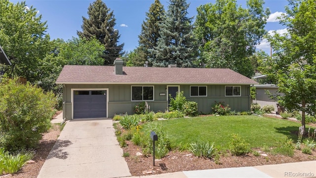3545 Cloverleaf Dr, Boulder, CO 80304 - single story home featuring a chimney, concrete driveway, a front lawn, and an attached garage