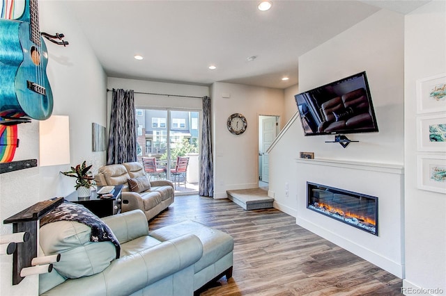 8361 Parkland St, Broomfield, CO 80021 - living room featuring baseboards, wood finished floors, recessed lighting, and a glass covered fireplace