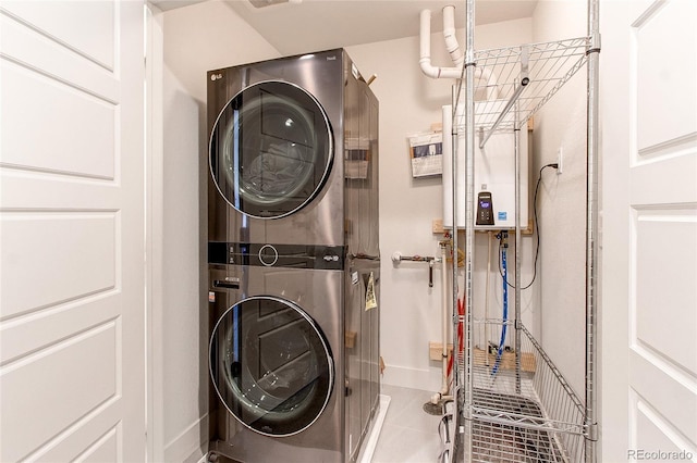 8361 Parkland St, Broomfield, CO 80021 - washroom featuring tankless water heater, visible vents, stacked washer and clothes dryer, laundry area, and tile patterned flooring