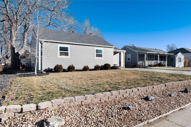 ranch-style house with a front yard and central AC unit