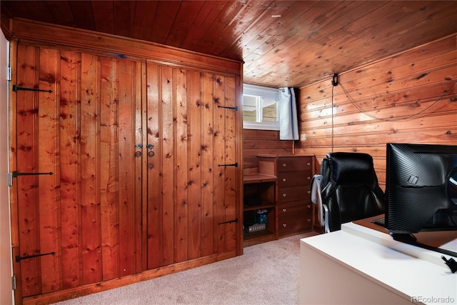 unfurnished office with light colored carpet, wooden ceiling, and wood walls