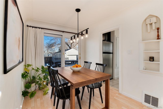 4920 Clay St, Denver, CO 80221 - dining area with baseboards, a notable chandelier, light wood-style flooring, and visible vents
