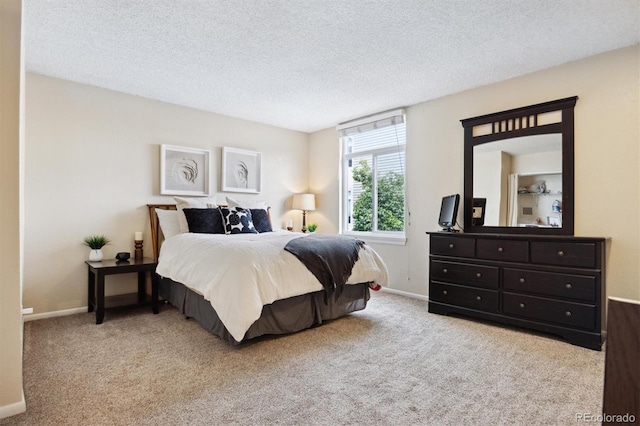 carpeted bedroom featuring a textured ceiling